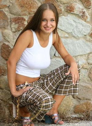 18 year old female Doris G slips off her underwear to pose naked on her bed